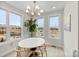 Sunlit dining room with large windows, stylish chandelier, and a round dining table with modern chairs at 1925 Dunavant St, Charlotte, NC 28203