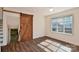 Bedroom features hardwood floors, a window for natural light, and a stylish sliding barn door at 2007 Nw Candlewood Nw Dr, Concord, NC 28027