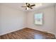 This bedroom features a ceiling fan, window and wood-look flooring at 2007 Nw Candlewood Nw Dr, Concord, NC 28027