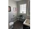 Neutral-toned bathroom with a glass block window, stylish vanity, and modern fixtures offers a serene space at 2220 The Plz, Charlotte, NC 28205
