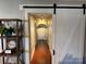 Hallway featuring hardwood floors, arched doorway and a sliding barn door at 2220 The Plz, Charlotte, NC 28205