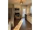 Well-lit kitchen features stainless steel appliances, tile flooring, and a door leading to the backyard at 2220 The Plz, Charlotte, NC 28205