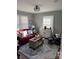 Cozy living room features a red sofa, stylish decor, hardwood floors, and natural light for a comfortable ambiance at 2220 The Plz, Charlotte, NC 28205
