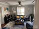 Bright living room with a comfortable blue sofa, stylish décor, and plenty of natural light at 2220 The Plz, Charlotte, NC 28205