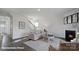 Living room with fireplace, wood floors, natural light, and staircase in the background at 2323 Riggs Rd, Sherrills Ford, NC 28673