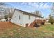 Backyard with wooden deck, grass, landscaping, and back of the house at 307 W Mcneely Ave, Mooresville, NC 28115