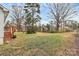 The property features a vast backyard with mature trees, grass, and a partially obstructed view of the home at 307 W Mcneely Ave, Mooresville, NC 28115