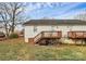View of the backyard with a wooden deck and stairs leading down to the grassy yard at 307 W Mcneely Ave, Mooresville, NC 28115
