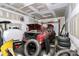 The garage contains a red sedan with its trunk open, surrounded by tires and car parts at 307 W Mcneely Ave, Mooresville, NC 28115