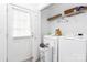 Laundry room with washer, dryer, exterior door, shelving, and tile flooring at 307 W Mcneely Ave, Mooresville, NC 28115