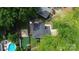 Aerial view of a landscaped backyard with a pool, patio, and lush greenery at 3516 Mill Stream Ct, Charlotte, NC 28209