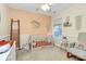 Cozy bedroom with neutral walls, wood crib, and a large window for natural light at 3516 Mill Stream Ct, Charlotte, NC 28209