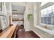 Hallway view with staircase, window seat, and a view into kitchen area with white cabinetry at 3516 Mill Stream Ct, Charlotte, NC 28209