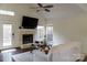 Bright living room featuring a cozy fireplace, modern lighting, and natural light from windows at 3516 Mill Stream Ct, Charlotte, NC 28209