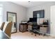 A modern office space with stylish desk, large monitor, and neutral decor at 3516 Mill Stream Ct, Charlotte, NC 28209