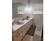 Bathroom featuring double sink with lavender basins, large mirror, and tiled floor at 4730 16Th Street Ne Dr, Hickory, NC 28602