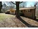 Single-story home featuring brick accents, a cozy front porch, and mature trees at 4730 16Th Street Ne Dr, Hickory, NC 28602