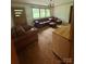 A Living Room featuring paneled door, and a brown sofa set with large picture window overlooking the outdoors at 4730 16Th Street Ne Dr, Hickory, NC 28602
