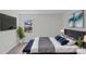 Modern bedroom features a large flat screen TV, an indoor plant, and a bed with blue pillows at 515 Richards Rd, Chester, SC 29706
