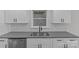 Close-up of the kitchen sink, faucet, and updated white cabinetry with modern hardware at 515 Richards Rd, Chester, SC 29706