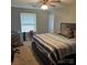 Bedroom features a window, bed, and ceiling fan at 5516 Northwood Dr, Hickory, NC 28601