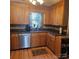 Well-maintained kitchen with wood cabinets, dark countertops, and modern stainless steel appliances at 5516 Northwood Dr, Hickory, NC 28601