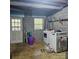 Unfinished basement featuring a laundry room with machines, concrete block walls, and doorway at 5516 Northwood Dr, Hickory, NC 28601
