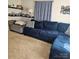 Comfortable living room featuring a large blue sofa, patterned pillows, and decorative shelving at 5516 Northwood Dr, Hickory, NC 28601