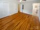 A well-lit room showcasing beautiful hardwood floors with doors and an ensuite at 5680 Hillsdale St, Fort Lawn, SC 29714