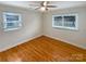 A well-lit room showcasing beautiful hardwood floors and two windows at 5680 Hillsdale St, Fort Lawn, SC 29714