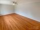 A well-lit room showcasing beautiful hardwood floors and a ceiling fan at 5680 Hillsdale St, Fort Lawn, SC 29714