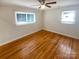 A well-lit room showcasing beautiful hardwood floors and two windows at 5680 Hillsdale St, Fort Lawn, SC 29714