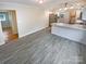 Open-concept room featuring kitchen with bright white cabinets and flooring at 5680 Hillsdale St, Fort Lawn, SC 29714