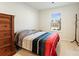 Clean and well-lit bedroom offers neutral color palette, a large window, and a wood dresser at 5775 Soft Shell Dr, Lancaster, SC 29720