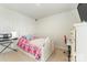 Bright bedroom with floral bedding, a keyboard, and a white desk with pink chair at 5775 Soft Shell Dr, Lancaster, SC 29720