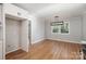 Bright dining room featuring hardwood floors, modern light fixture, neutral paint and a large window at 6007 Charing Pl, Charlotte, NC 28211