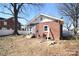 The backyard features a small deck, brick siding, and some dormant landscaping at 604 Pearl Ave, Kannapolis, NC 28083