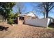 Exterior shot of backyard showcasing a white privacy fence and a brick section connected to the home at 604 Pearl Ave, Kannapolis, NC 28083