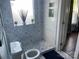 Stylish bathroom features blue and white patterned tile, open shelving, and natural light at 604 Pearl Ave, Kannapolis, NC 28083