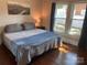Cozy bedroom with hardwood floors, a comfortable bed, and ample natural light from the windows at 604 Pearl Ave, Kannapolis, NC 28083