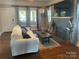 Bright living room with hardwood floors, a fireplace, and large windows providing natural light at 604 Pearl Ave, Kannapolis, NC 28083