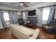 Cozy living room featuring hardwood floors, a decorative fireplace, and plenty of natural light from the windows at 604 Pearl Ave, Kannapolis, NC 28083