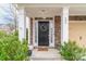 Inviting front entrance with stone pillars, seasonal wreath, and a welcome mat at 605 Lumber Ln, Charlotte, NC 28214