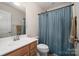 Bathroom featuring a single sink vanity and shower-tub combo at 6830 Colonial Garden Dr, Huntersville, NC 28078