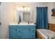 Bathroom with double sinks, tiled backsplash, and blue vanity at 6830 Colonial Garden Dr, Huntersville, NC 28078