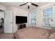 Bedroom featuring a ceiling fan, bright window, and mounted television at 6830 Colonial Garden Dr, Huntersville, NC 28078