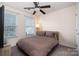 Bedroom featuring a ceiling fan, bright window, and neutral colors at 6830 Colonial Garden Dr, Huntersville, NC 28078