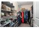 A walk-in closet with shoe racks, hanging rods, and built-in shelving at 6830 Colonial Garden Dr, Huntersville, NC 28078