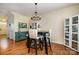 Cozy dining area featuring a modern chandelier and a display cabinet for storing favorite items at 6830 Colonial Garden Dr, Huntersville, NC 28078