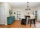 Charming dining space with a unique light fixture, wood floors and lots of natural light at 6830 Colonial Garden Dr, Huntersville, NC 28078